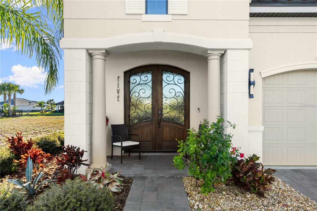 A front entryway features a double door with iron scrollwork under a covered porch — 5 RIO VISTA DRIVE, PALM COAST, FL
