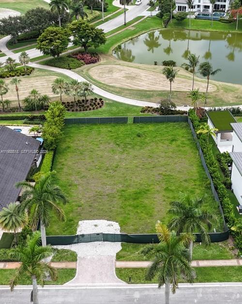 An aerial view shows a vacant, fenced residential lot next to a pond and golf course — 17591 Scarsdale Way, Boca Raton FL 33496, BOCA RATON, FL