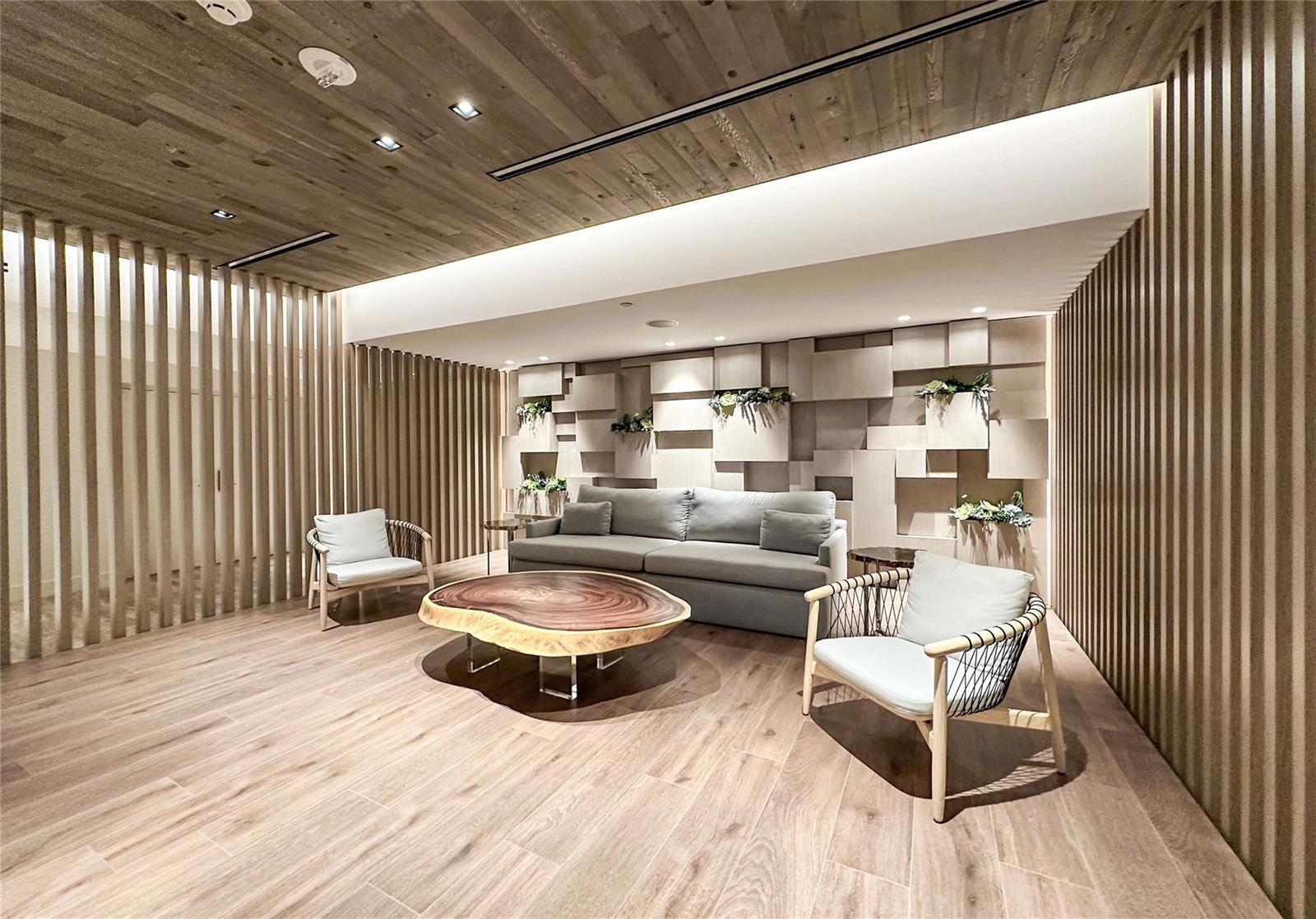 A modern living room features wood-slat walls, a live-edge coffee table, and a geometric accent wall — 2301 Collins Avenue # 1015, Miami Beach FL 33139, MIAMI BEACH, FL