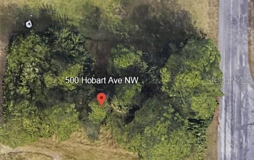 This is a satellite map view of a heavily wooded, undeveloped lot — 500 HOBART AVENUE NW, PALM BAY, FL