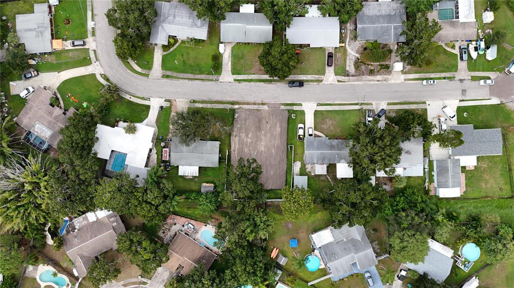 An aerial view shows a residential neighborhood with a vacant, cleared lot between two houses — 436 COUNTRY CLUB DRIVE, OLDSMAR, FL