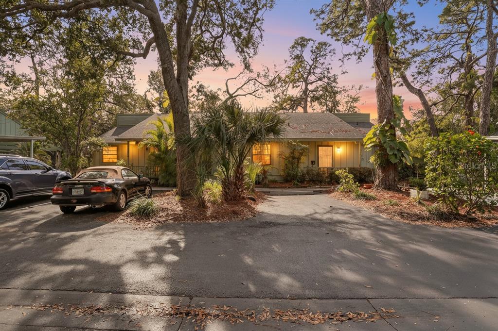 A covered front porch with a tiled floor leads to a door with a metal gate — 5014 BARRINGTON CIRCLE UNIT 2102, SARASOTA, FL