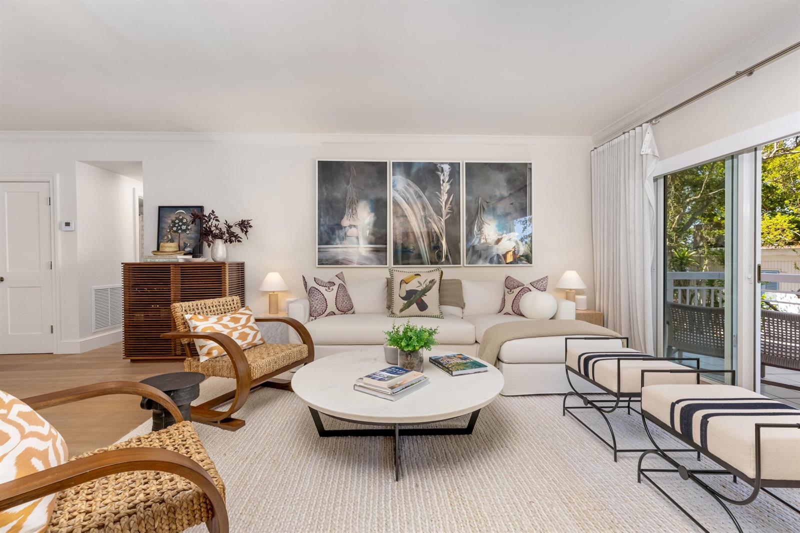 A bright living room features a white sectional sofa, round coffee table, and woven chairs — 250 Bradley Place # 307, Palm Beach FL 33480, PALM BEACH, FL