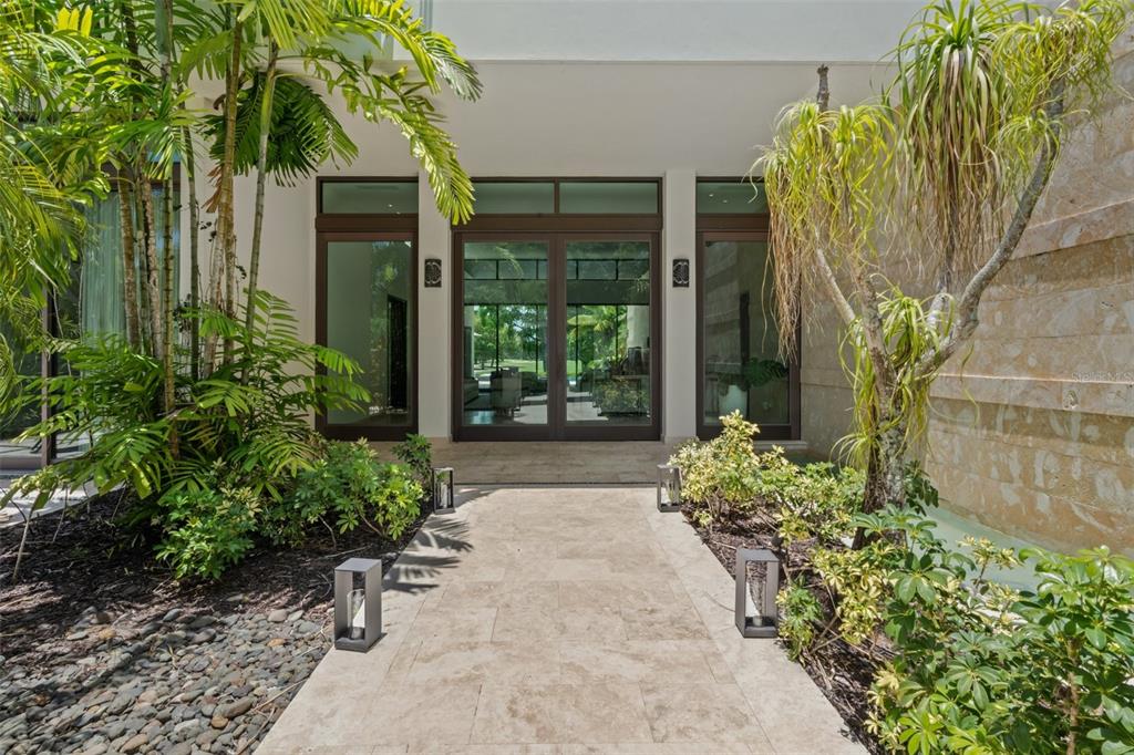 A stone walkway leads to the glass-paned double front doors of a modern home — 2200 DORADO BEACH DR UNIT 3, DORADO, PR