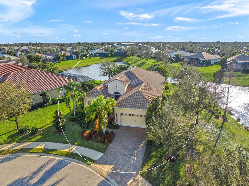 An aerial view of a single-story house with a tile roof and a brick driveway — 7108 CALLANDER COVE, LAKEWOOD RANCH, FL