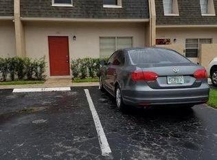 A gray sedan is parked in front of a townhouse with a red front door — 1307 Partridge # 67, Pompano Beach FL 33064, POMPANO BEACH, FL