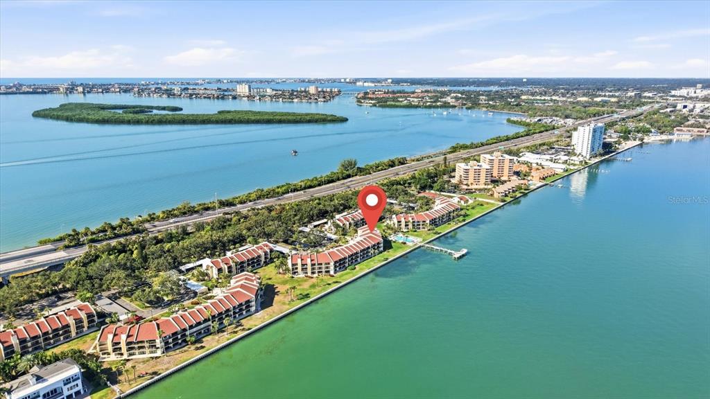 An aerial view shows a waterfront condominium complex with a red location pin — 7520 SUNSHINE SKYWAY LANE S UNIT T19, ST PETERSBURG, FL