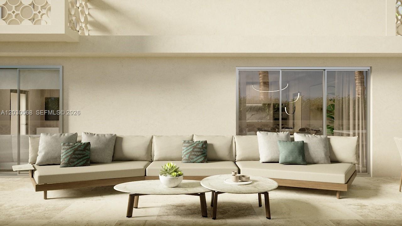 This rendering shows a modern outdoor patio featuring a large sectional sofa and two coffee tables — 260 Collins Ave # 110, Miami Beach FL 33139, MIAMI BEACH, FL