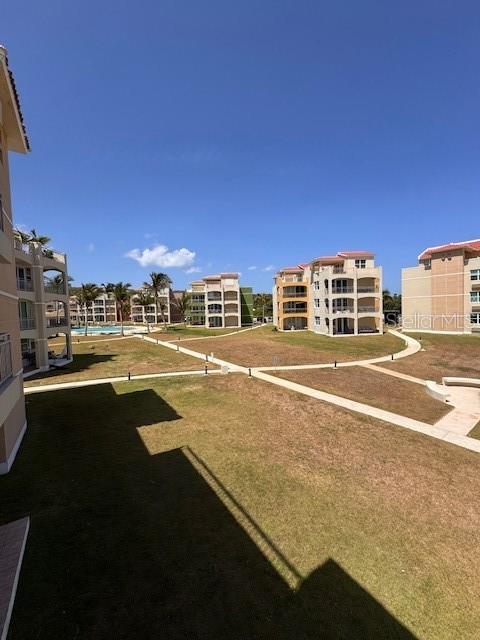 An elevated view shows multiple multi-story apartment buildings surrounded by grassy lawns and paved walkways — 67 AQUAMARINA UNIT Jobos, ISABELA, PR