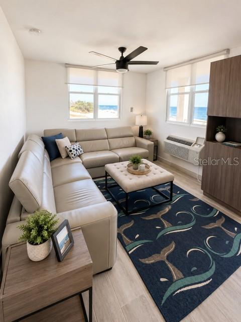 A living room with a light-colored sectional sofa, a tufted ottoman, and ocean views — 67 AQUAMARINA UNIT Jobos, ISABELA, PR