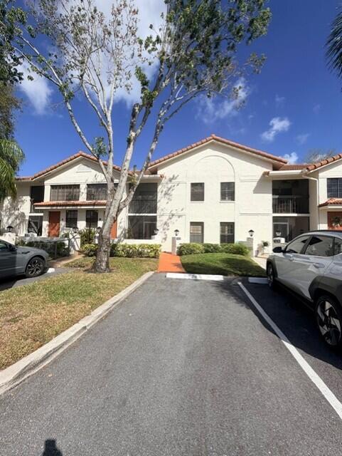 A two-story apartment building with a paved parking area and a large tree in front — 9784 Pavarotti Terrace # 102, Boynton Beach FL 33437, BOYNTON BEACH, FL