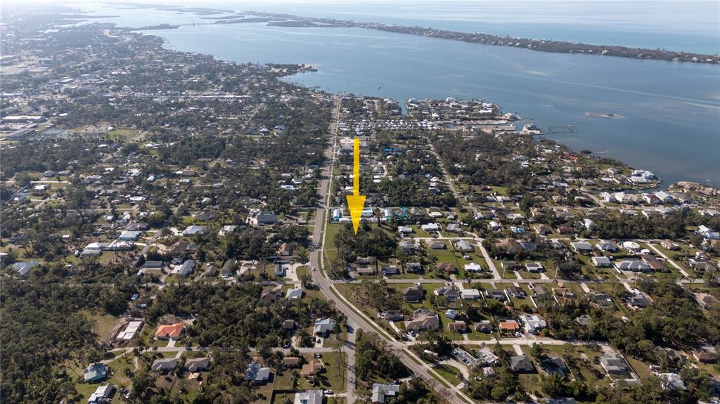 An aerial view shows a residential neighborhood with a yellow arrow pointing toward a lot — OLD ENGLEWOOD ROAD, ENGLEWOOD, FL