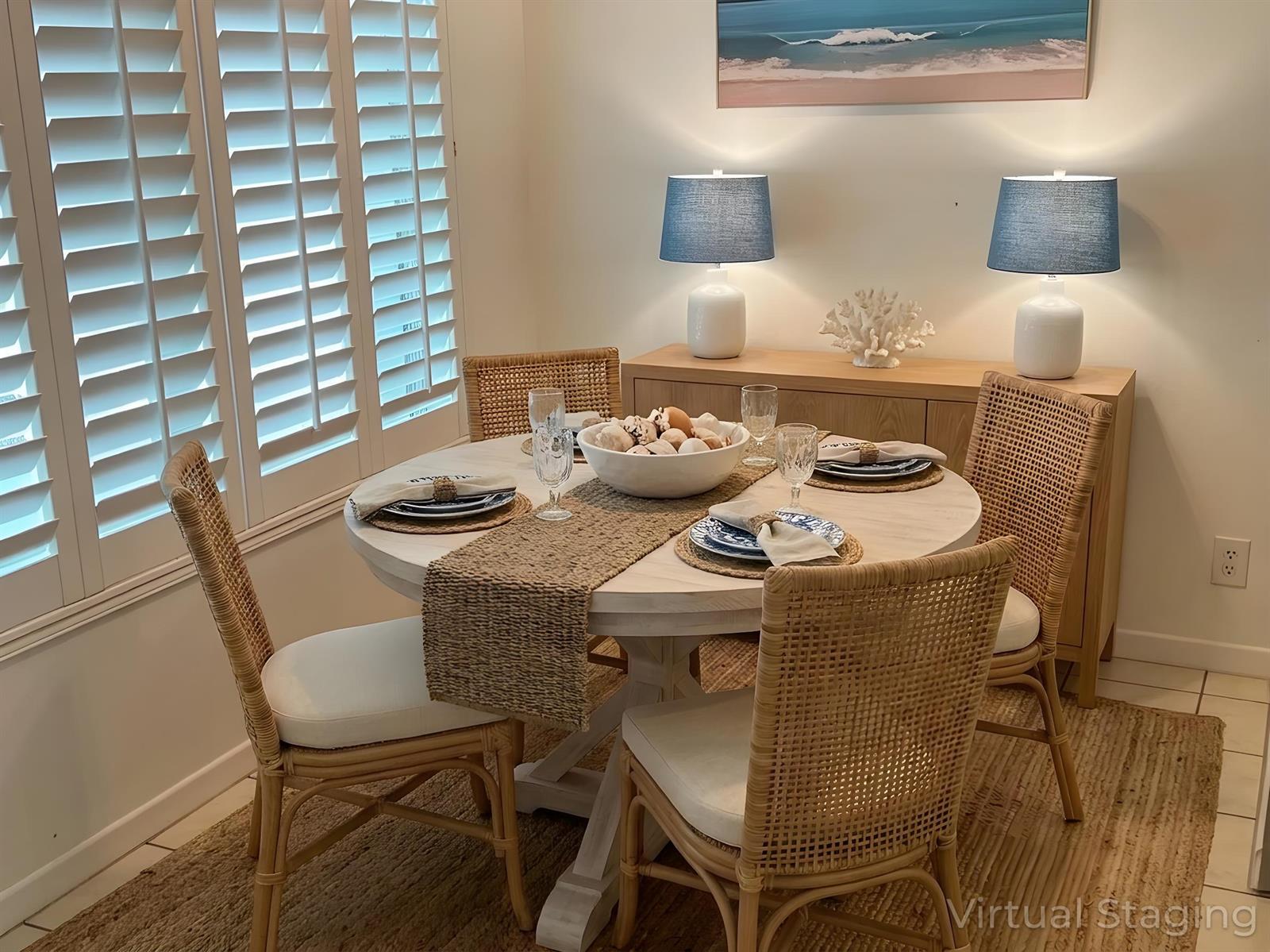 A dining room features a round table with four rattan chairs and a wooden sideboard — 702 N Federal Highway # A8, FL 33460, FL