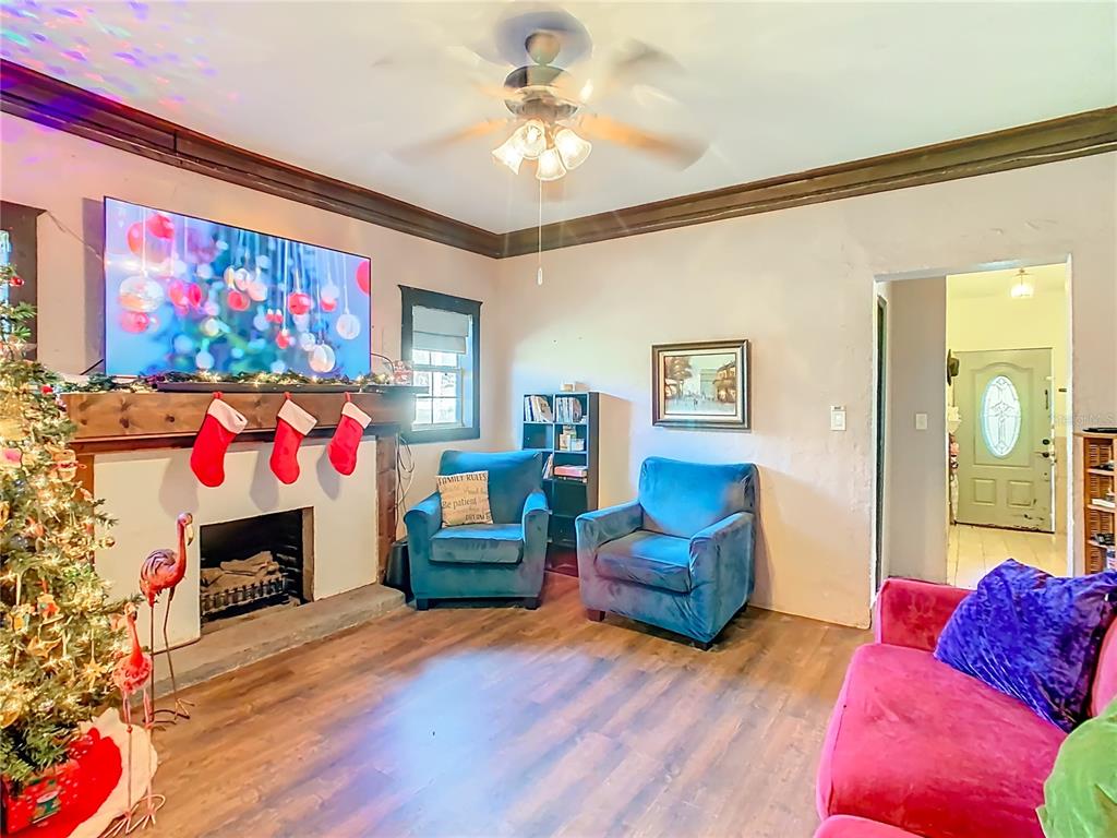 A living room features a fireplace with stockings, two blue armchairs, and a pink sofa — 900 N 30TH STREET, HAINES CITY, FL