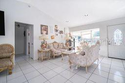 A living room features white tile flooring, ornate furniture, and a white front door — 14 CEDAR TRACE TERRACE, OCALA, FL