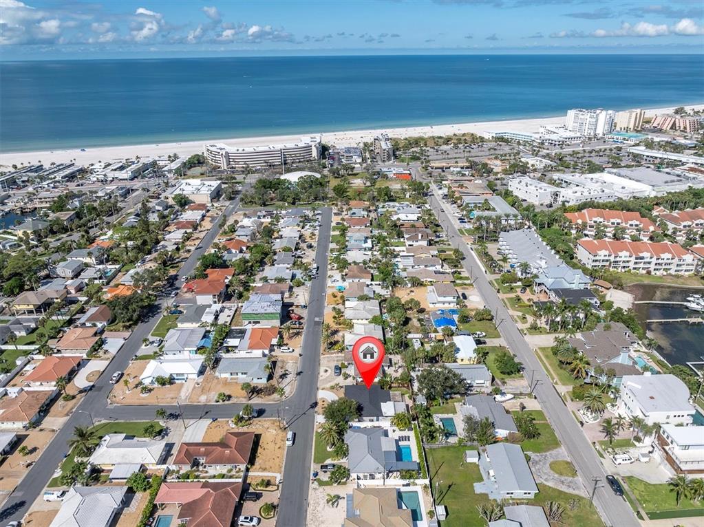 An aerial view shows a residential neighborhood near a beach with a red location pin — 197 LIDO DRIVE, ST PETE BEACH, FL