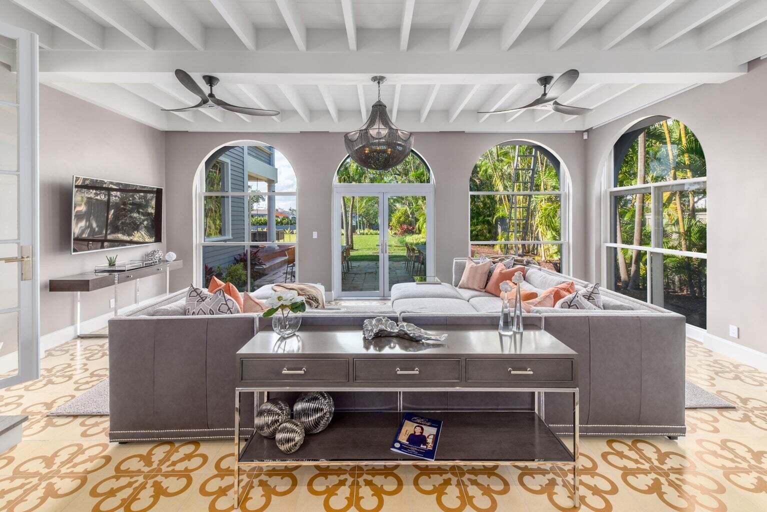 A living room features a large sectional sofa, arched windows, and a patterned tile floor — 15 S Lake Trail, Palm Beach FL 33480, PALM BEACH, FL