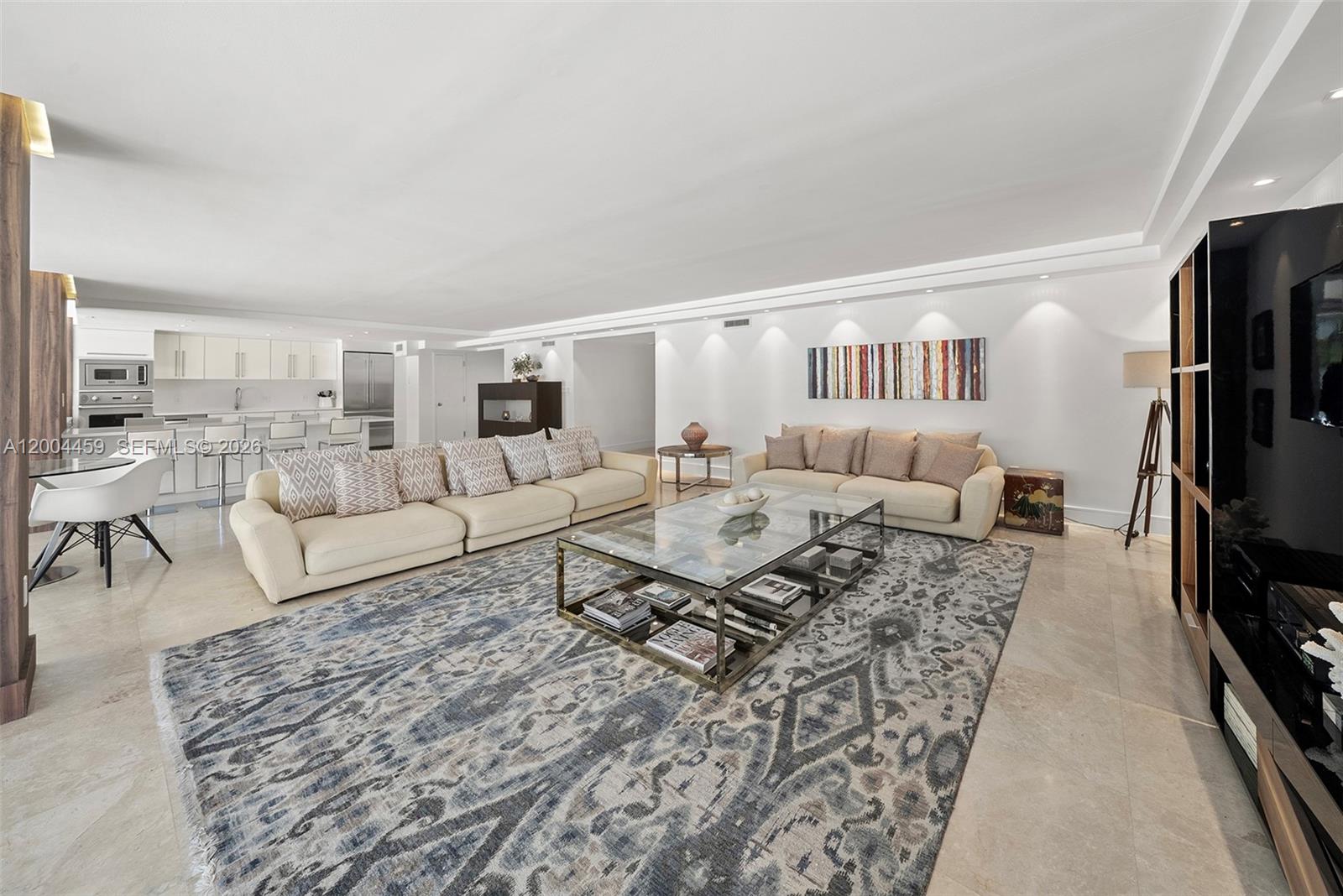 A spacious living room features a large area rug, two beige sofas, and a glass-topped table — 600 Grapetree Dr, Key Biscayne FL 33149, KEY BISCAYNE, FL