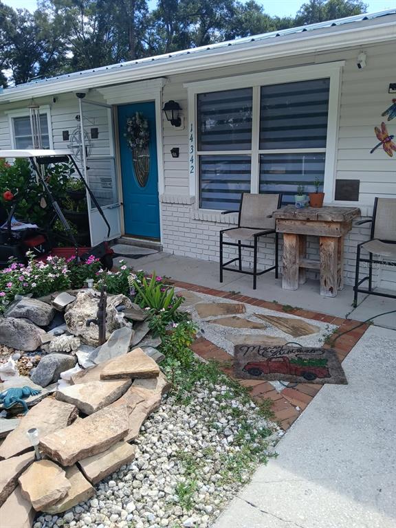 A kitchen with white cabinets, granite countertops, a center island, and three white bar stools — 14342 SE 45TH COURT, SUMMERFIELD, FL
