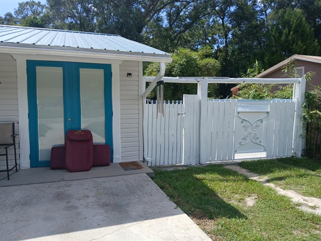 A living room features a white sectional sofa, a dark coffee table, and teal curtains — 14342 SE 45TH COURT, SUMMERFIELD, FL