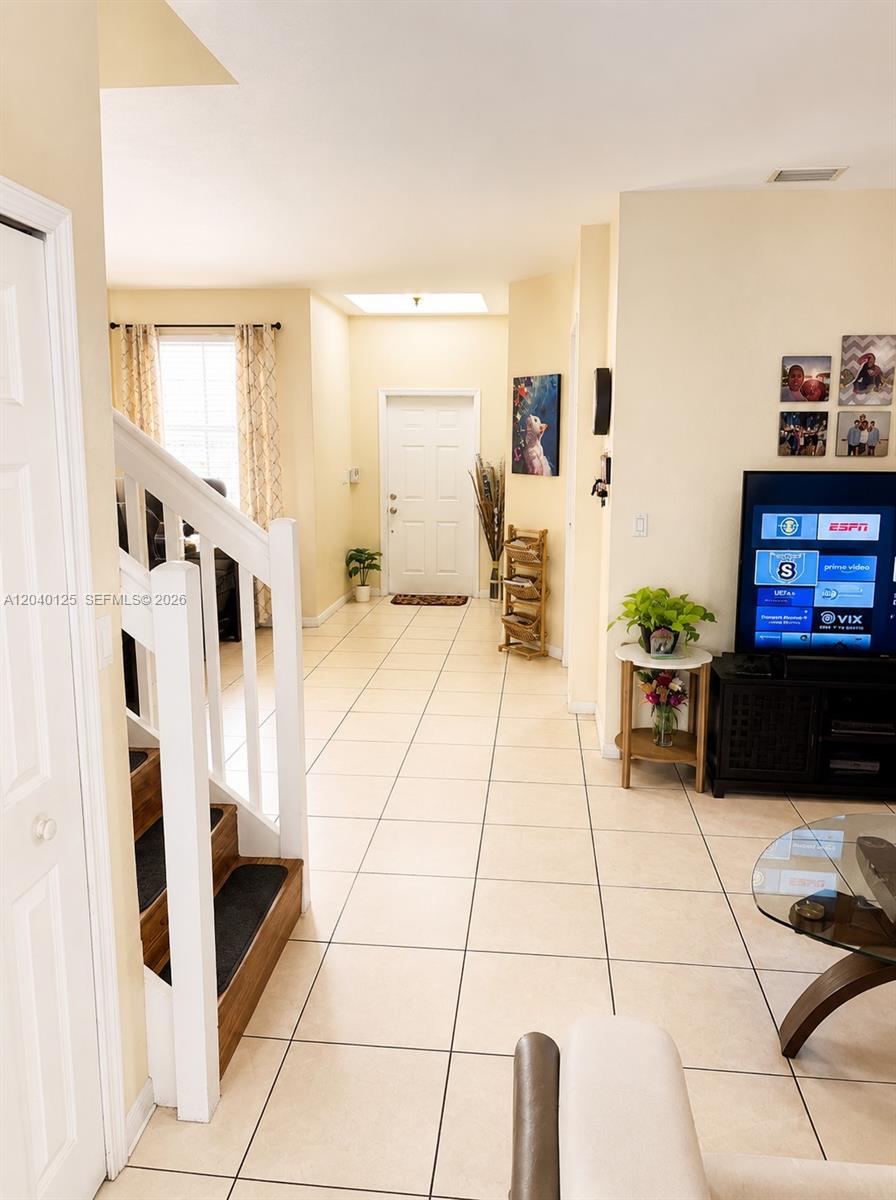 A tiled entryway leads to a front door with a skylight above and a staircase — 12488 SW 122nd St, Miami FL 33186, MIAMI, FL