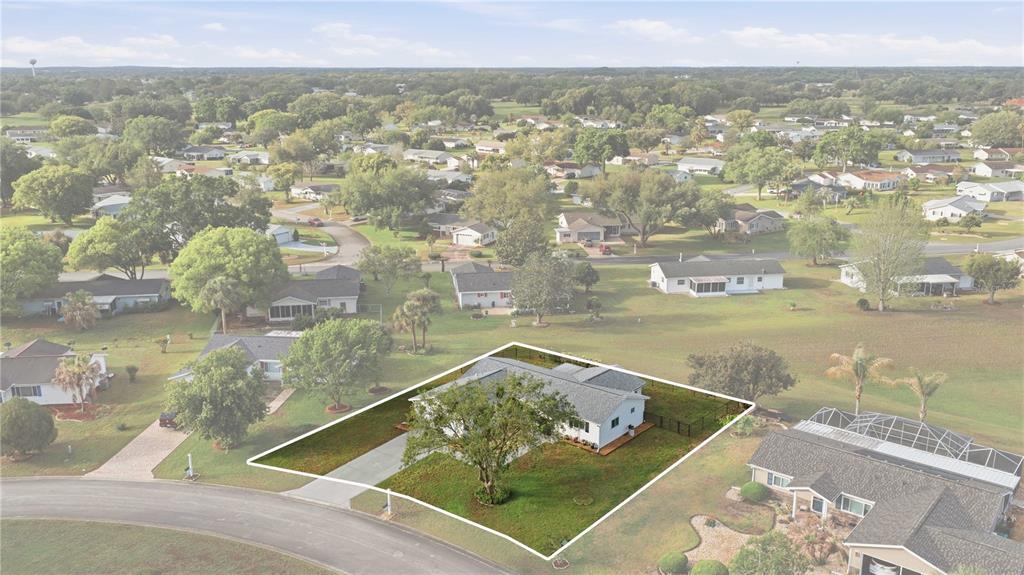 An aerial view shows a single-story house with a large tree in the front yard — 17710 SE 105TH TERRACE, SUMMERFIELD, FL