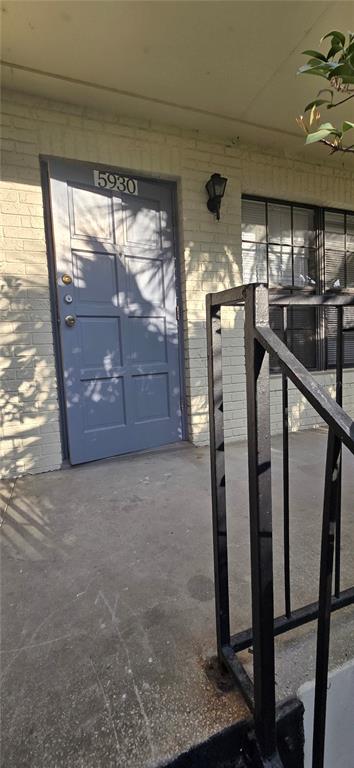 A gray front door with the number 5930 sits on a concrete porch with railings — 5930 VILLAGE CIRCLE UNIT GE, ORLANDO, FL