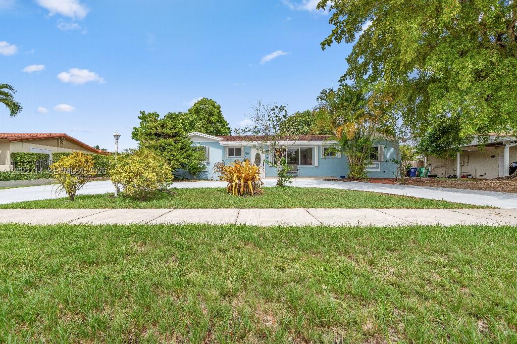 A light blue, single-story house with a white driveway and a large front lawn — 7311 SW 139th Ave, Miami FL 33183, MIAMI, FL