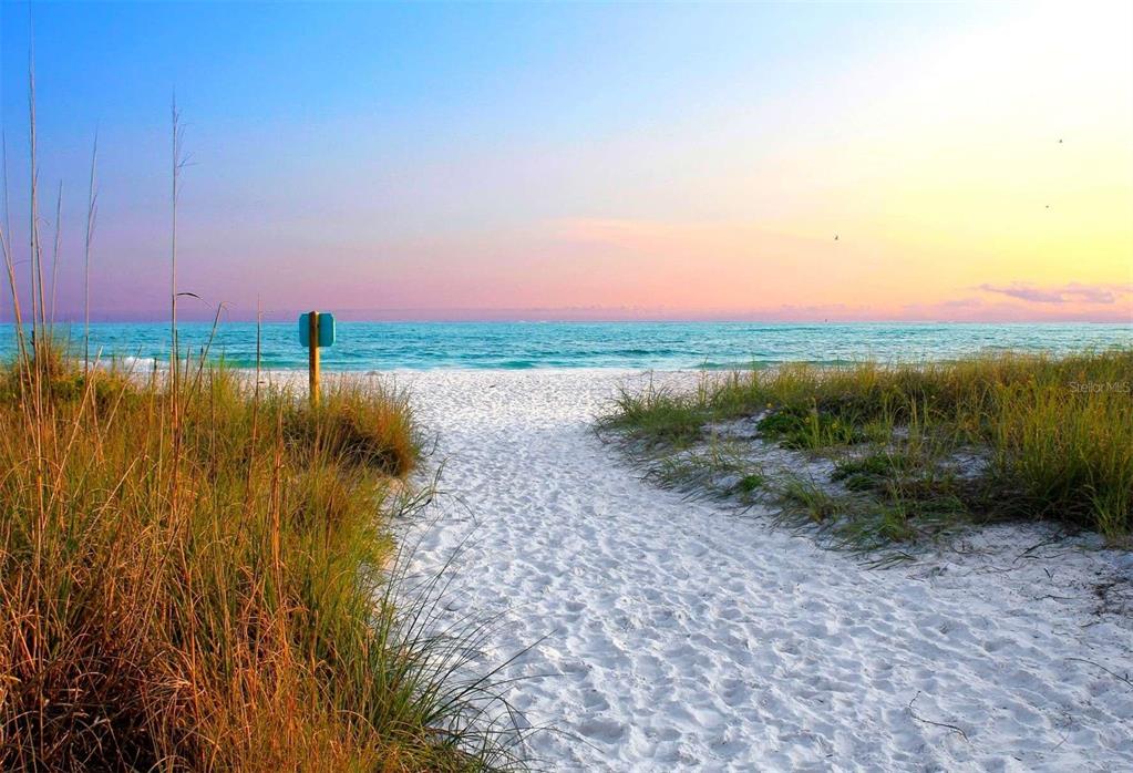 A sandy path leads through beach grass toward the ocean at sunset — 4660 OCEAN BOULEVARD UNIT Q, SARASOTA, FL