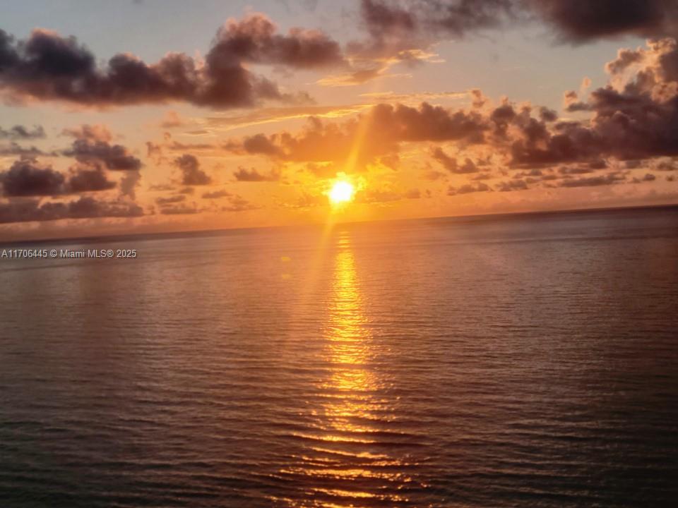 A view of the ocean at sunset with a golden reflection on the water — 5601 Collins Ave # 9, Miami Beach FL 33140, MIAMI BEACH, FL