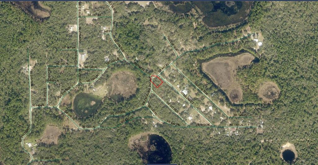 An aerial map shows a highlighted rectangular property lot surrounded by wooded land and roads — 5075-042-034 SE 217TH AVENUE, UMATILLA, FL