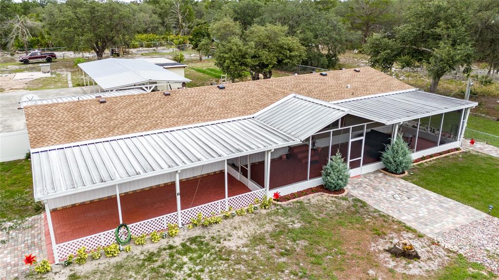 An aerial view of a house with a large metal-roofed screened porch and patio — 4350 TIMMERMAN AVENUE, LAKE WALES, FL