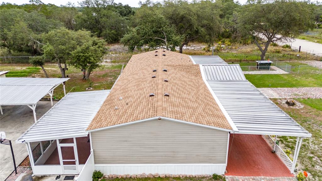 An aerial view of a manufactured home with a shingled roof and metal-covered patios — 4350 TIMMERMAN AVENUE, LAKE WALES, FL