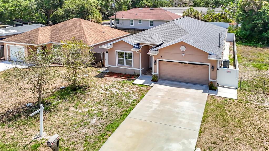 An aerial view shows two adjacent single-story houses with driveways and sparse lawns — 5065 67TH WAY N, ST PETERSBURG, FL