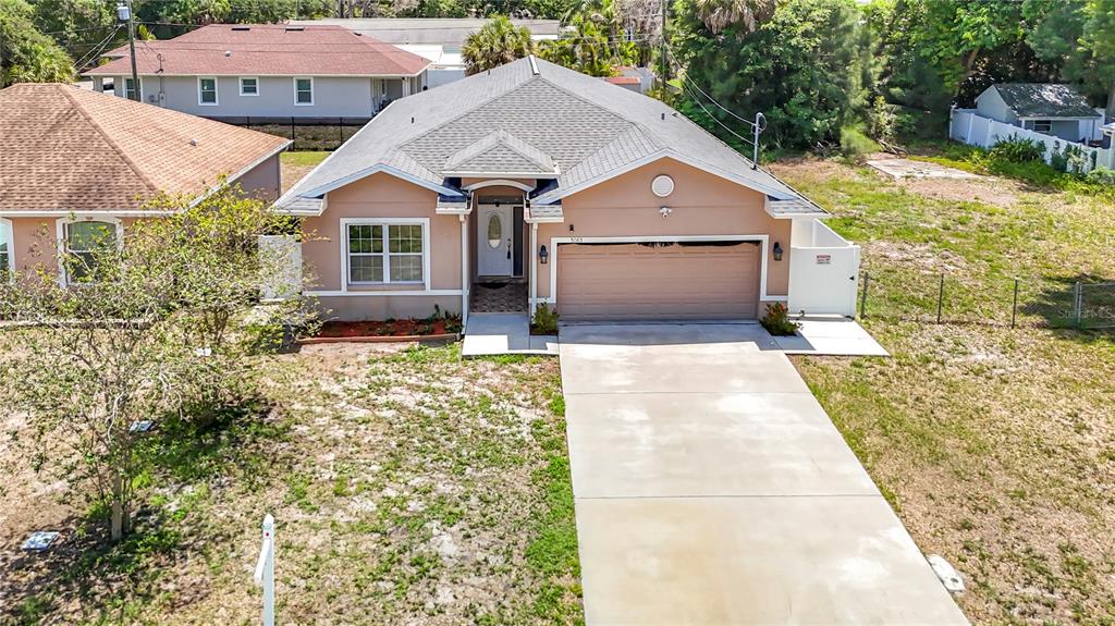 An aerial view shows a tan, single-story house with a two-car garage and concrete driveway — 5065 67TH WAY N, ST PETERSBURG, FL