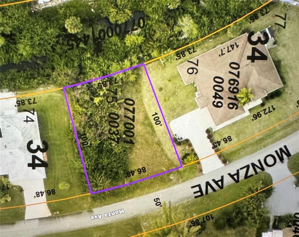 This is an aerial map showing a vacant residential lot outlined in purple on Monza Avenue — MONZA AVENUE, NORTH PORT, FL