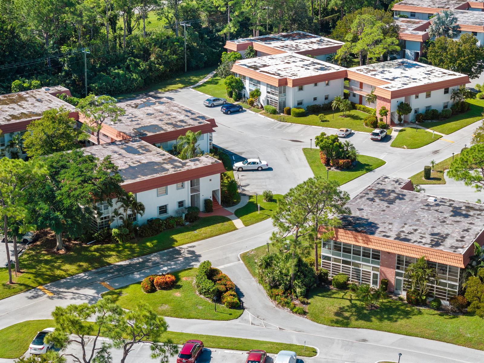 An aerial view shows several multi-story apartment buildings with flat roofs and surrounding parking lots — 2600 SE Ocean Boulevard # N14, Stuart FL 34996, STUART, FL