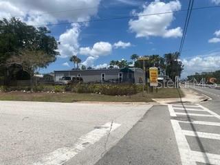 A single-story manufactured home sits on a corner lot with a yellow sign nearby — 9200 66TH STREET N, PINELLAS PARK, FL
