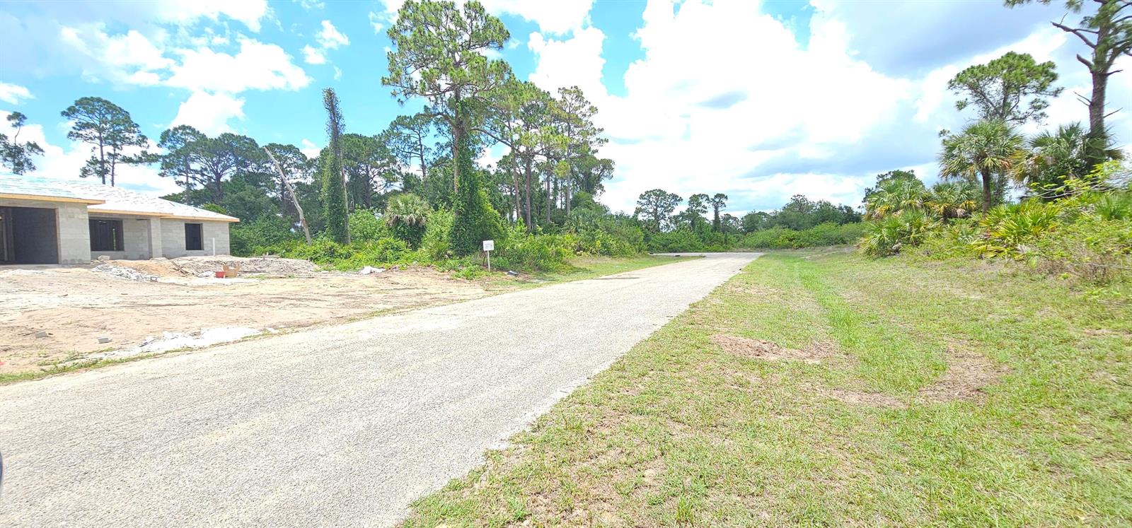 A gravel road leads past a house under construction toward a wooded area — 6204 Hob Court, FL 33935, FL