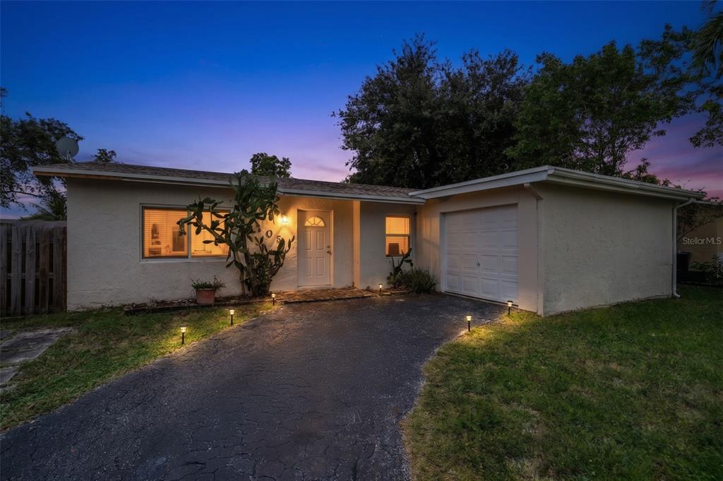 A single-story house with a white stucco exterior, a driveway, and a one-car garage — 405 SW 77TH AVENUE, NORTH LAUDERDALE, FL