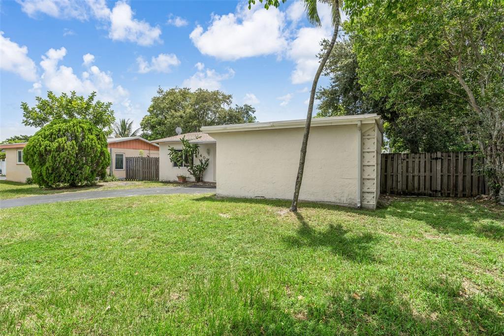 A single-story house with a flat roof and a large grassy front yard — 405 SW 77TH AVENUE, NORTH LAUDERDALE, FL
