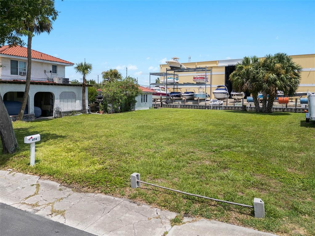 A grassy vacant lot sits next to a house and a boat storage facility — 274 LEXINGTON DRIVE, DAYTONA BEACH, FL