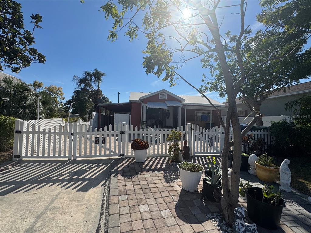 A single-story house with a white picket fence and a paved driveway — 2312 W LA SALLE STREET, TAMPA, FL