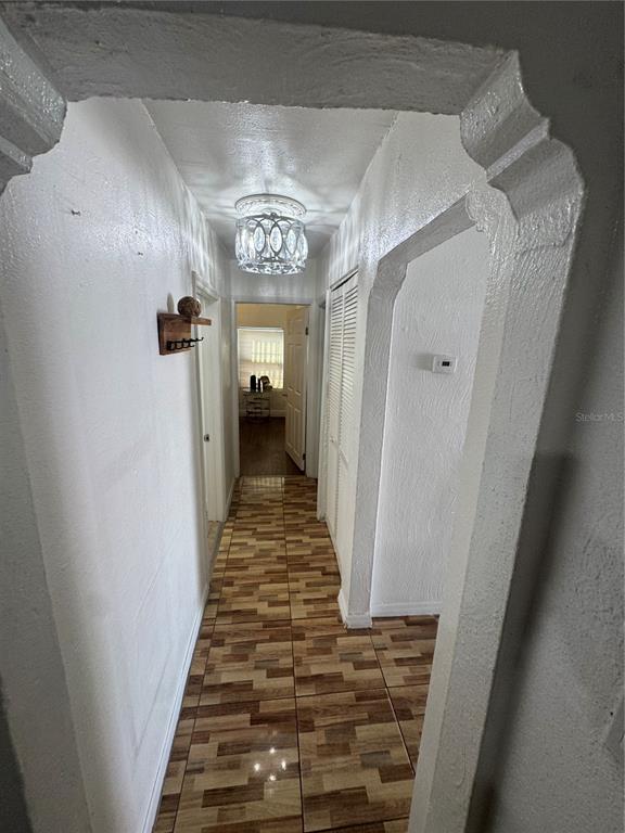 A hallway with white walls, a patterned tile floor, and an arched entryway — 2312 W LA SALLE STREET, TAMPA, FL