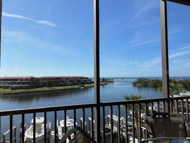 A view of a waterway and boats from a screened-in balcony — 3313 SUNSET KEY CIRCLE UNIT 203, PUNTA GORDA, FL