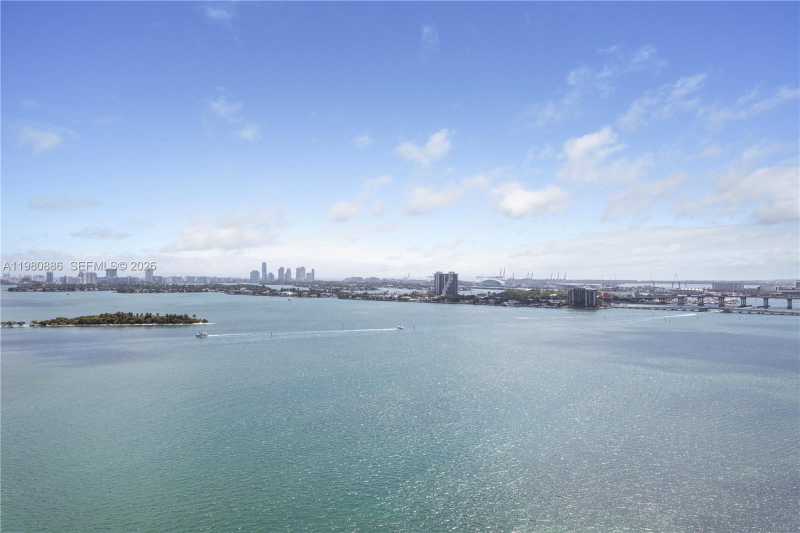 A high-angle view shows a wide bay with distant city skylines and a bridge — 665 NE 25th St # 2102, Miami FL 33137, MIAMI, FL