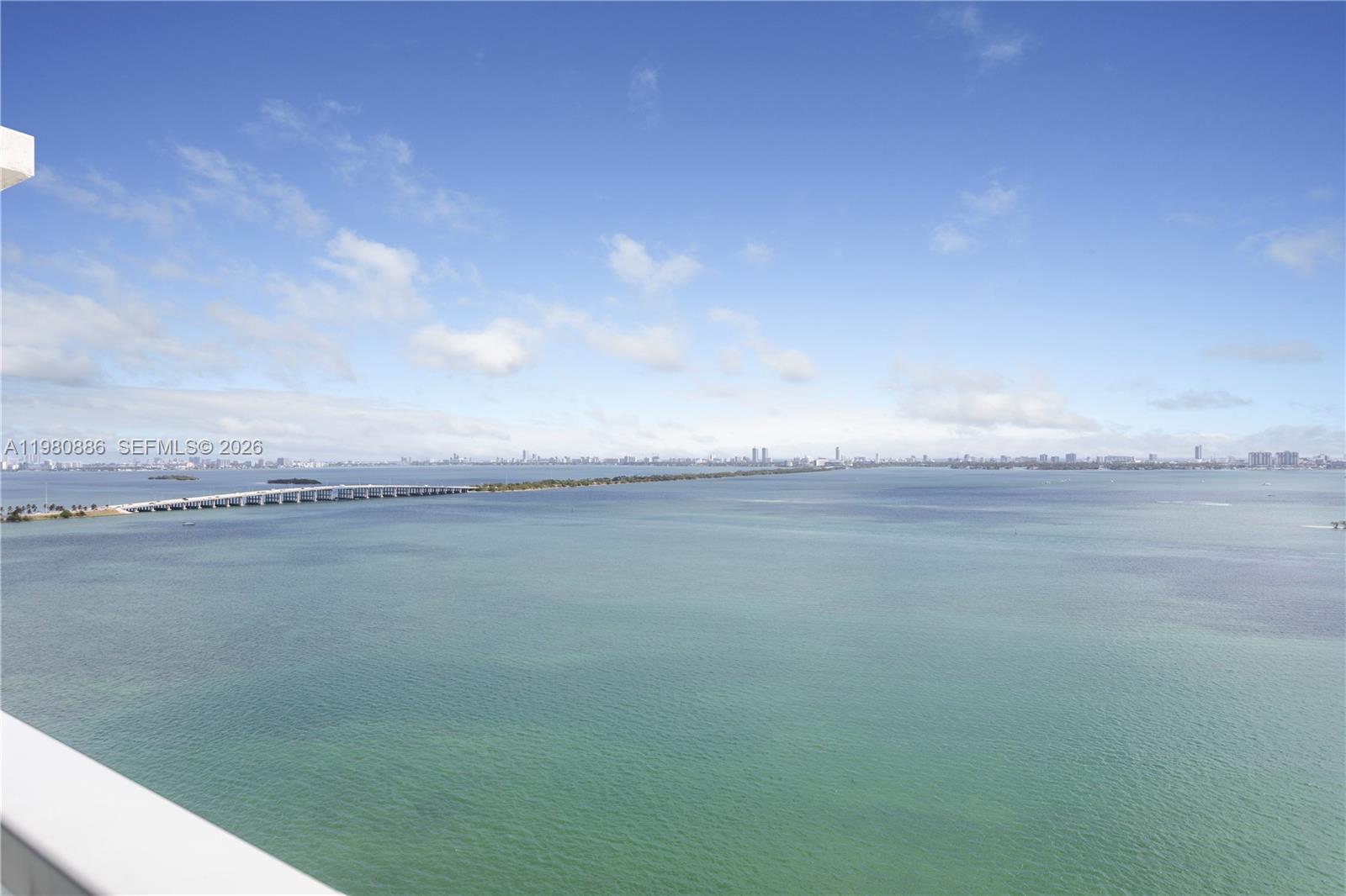 A high-angle view shows a bridge spanning across a large body of water — 665 NE 25th St # 2102, Miami FL 33137, MIAMI, FL