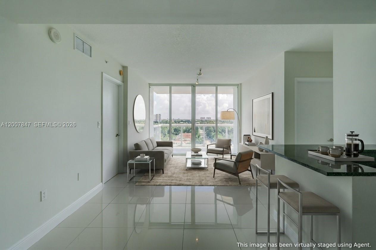 A modern living room with tile floors, a balcony, and virtual staging furniture — 1871 NW S River Dr # 802, Miami FL 33125, MIAMI, FL