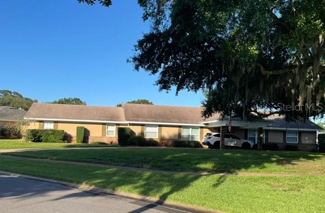 A single-story house with a tan exterior and a large tree in the front yard — 130 SPRINGWOOD TRAIL, ALTAMONTE SPRINGS, FL