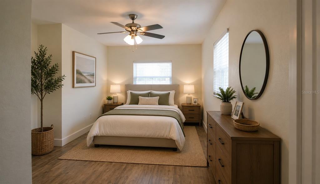 A bedroom features a queen bed, wooden dresser, ceiling fan, and a round wall mirror — 2511 W VIOLET STREET, TAMPA, FL